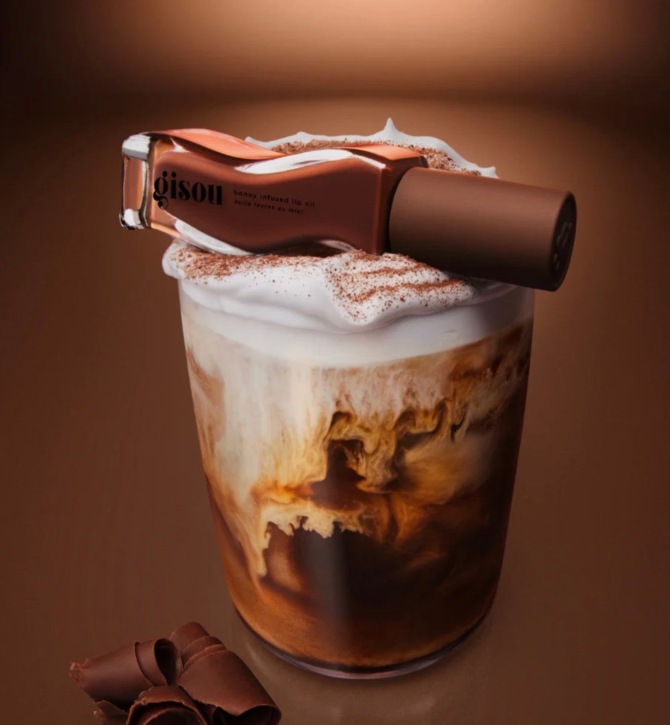 GISOU- A sheer-but-buildable milky brown with cool undertones, inspired by a fireside cup of mocha. Swipe on the tint and scent of chocolate espresso with a creamy top for lips that are intensely hydrated and boosted with glossy shine